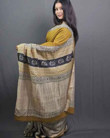 Woman wearing a traditional outfit with intricate patterns on a gray background