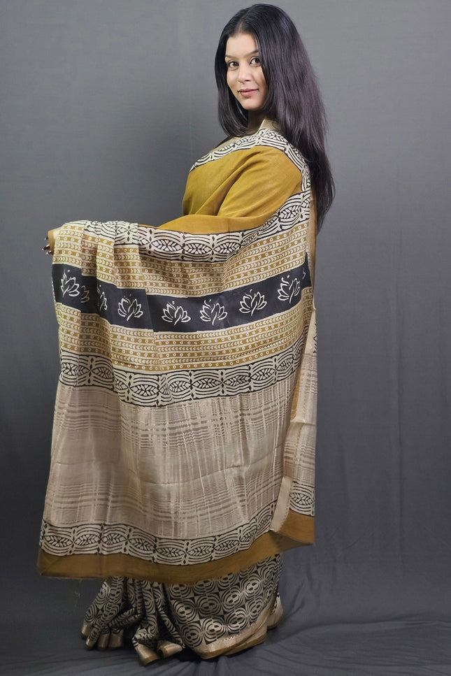 Woman wearing a traditional outfit with intricate patterns on a gray background
