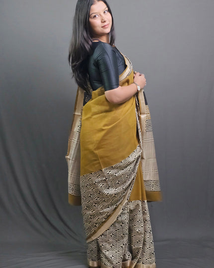 Woman holding a traditional saree with a gray background