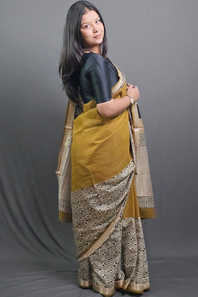 Woman holding a traditional saree with a gray background