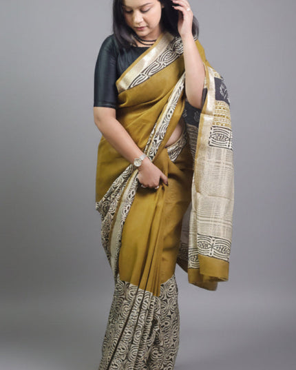 Woman wearing a traditional saree with a plain background