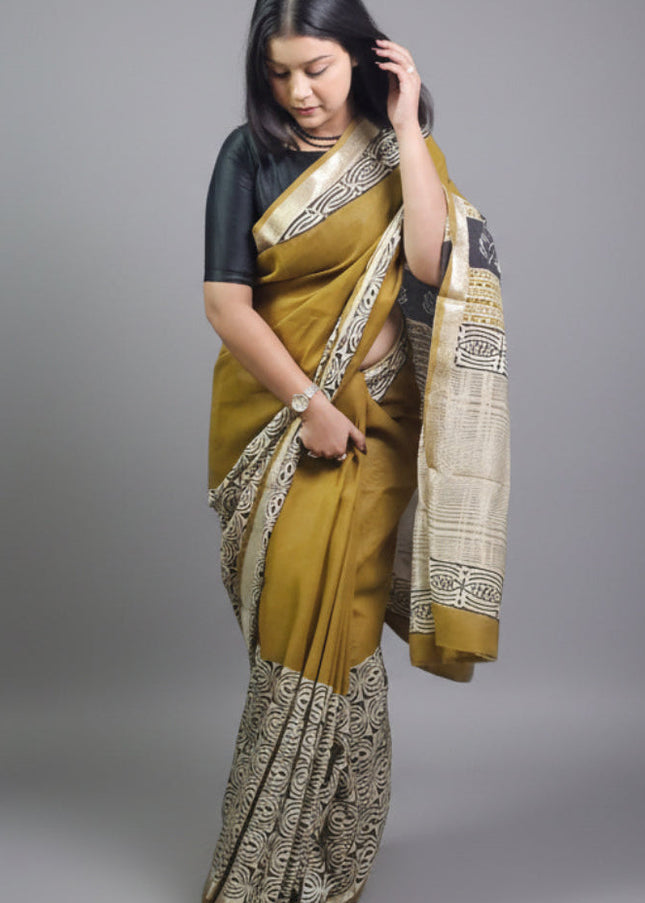 Woman wearing a traditional saree with a plain background