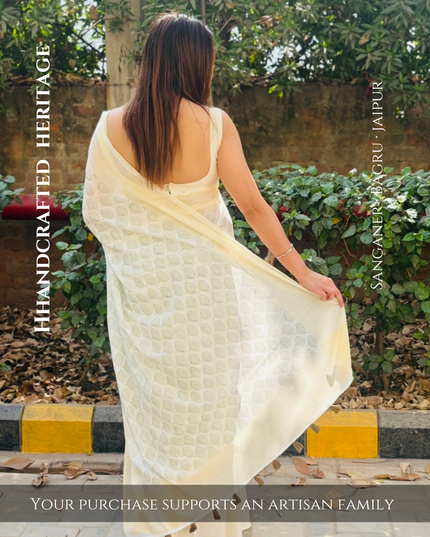 Woman wearing a cream saree with text about handcrafted heritage and artisan support.