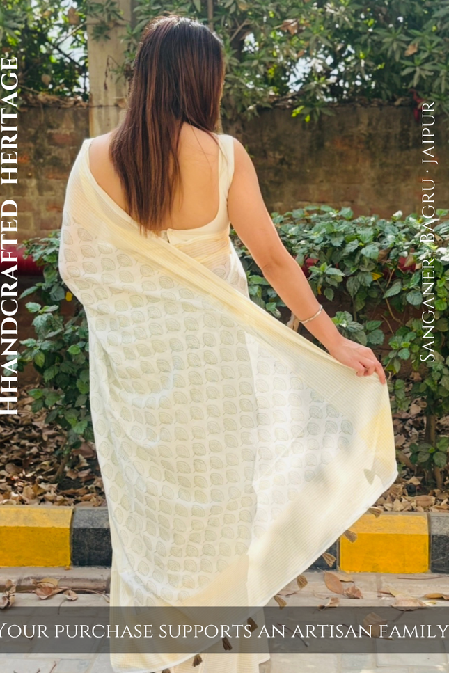 Woman wearing a cream saree with text about handcrafted heritage and artisan support.