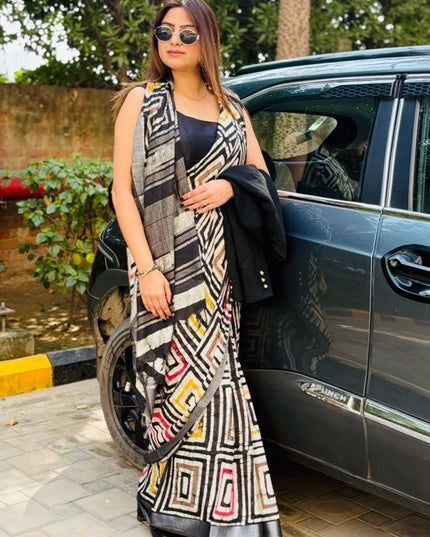 Woman in a patterned dress standing next to a car outdoors